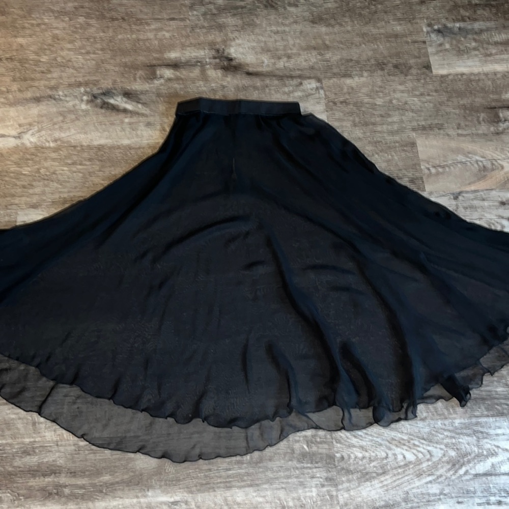 Past knee-length sheer black ballet skirt.